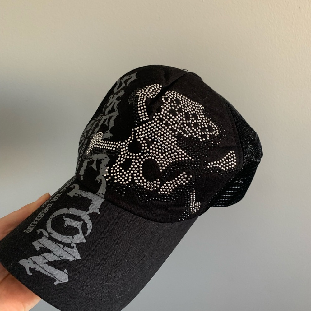 Black trucker hat with skull designs and rhinestones with adjustable straps